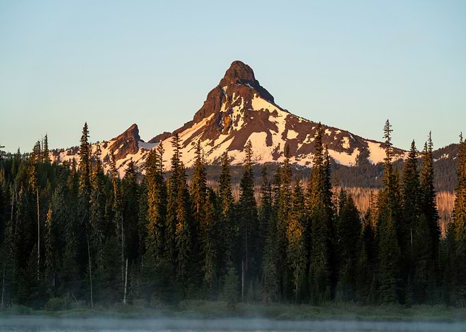 Misty Lake and Snow-Capped Mountain