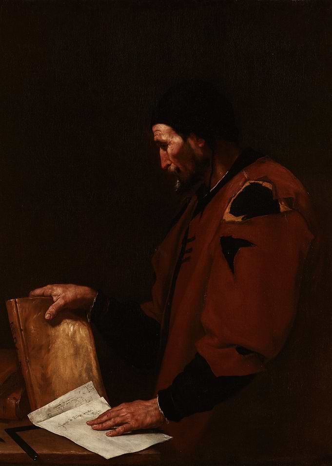 Man reading a book and papers