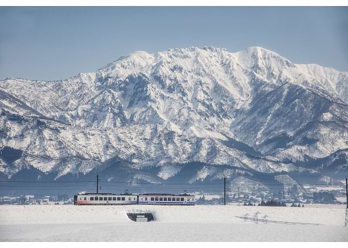 Train in Snowy Mountains