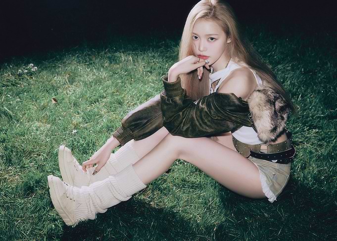 Fashionable izna jeong saebi sitting on grass