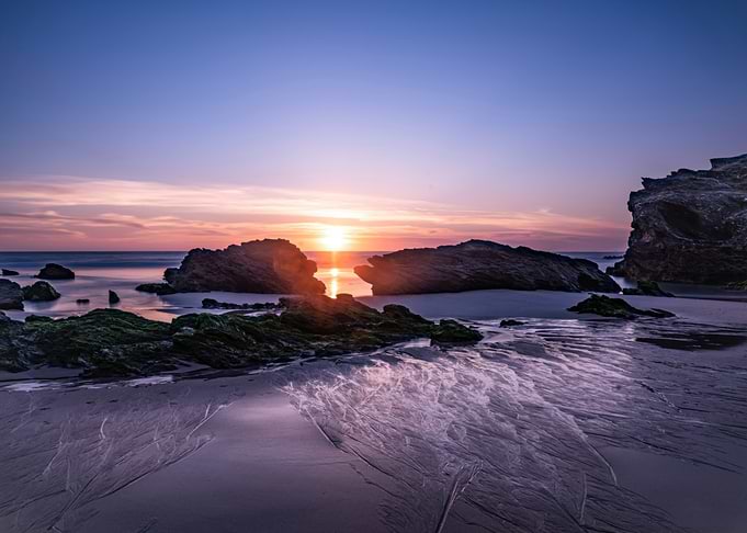 Sunset over rocky beach