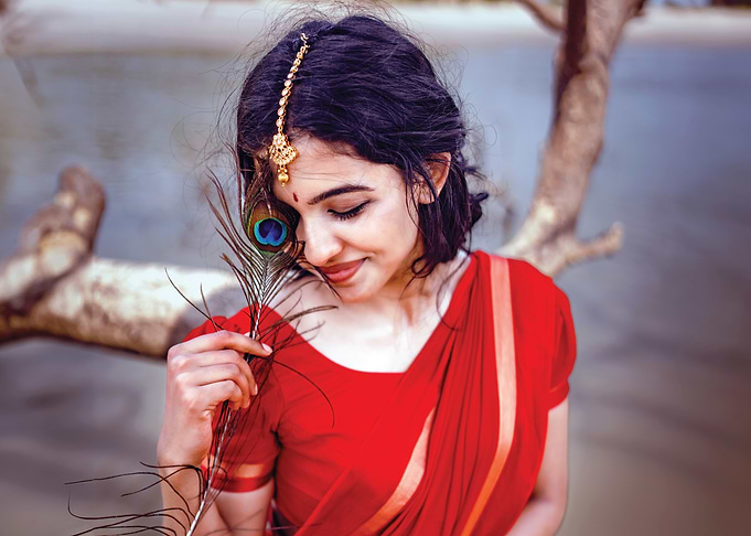 mamitha baiju in Red Saree with Peacock Feather