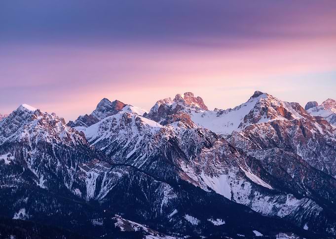 Snow-capped mountains at sunset