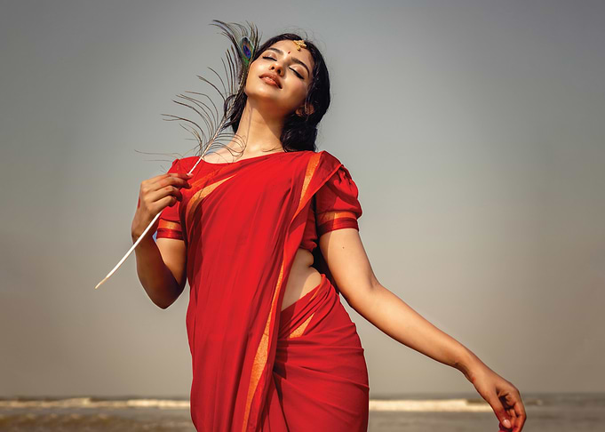 mamitha baiju in Red Saree with Peacock Feather