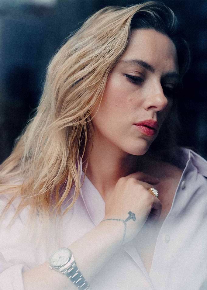 Woman in a light purple shirt with jewelry