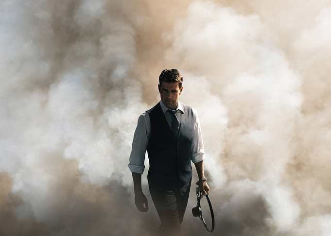 Man walking through smoke holding steering wheel tom cruise