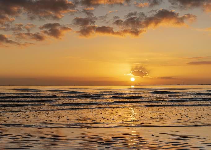Sunset over the ocean with clouds