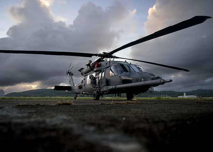 Military Helicopter on Tarmac at Dusk
