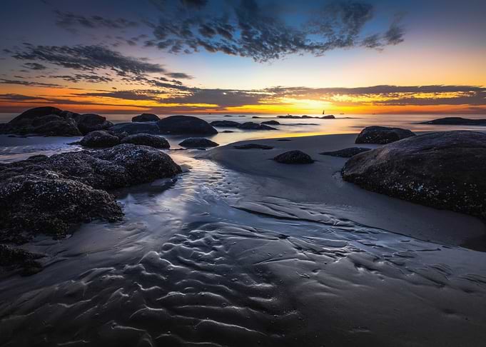 Dramatic Sunset Over Rocky Beach