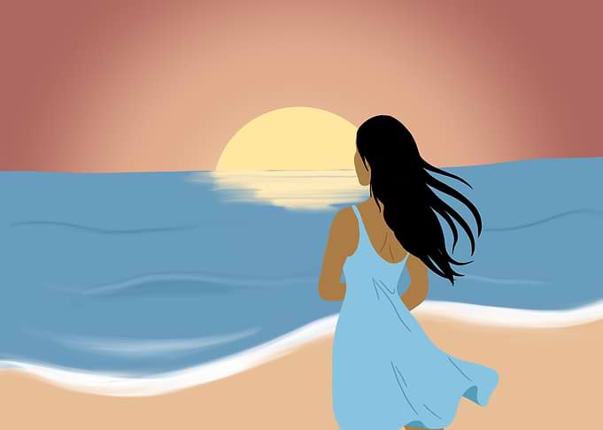 Woman watching sunset over the ocean