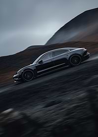 Black Porsche Taycan on a Dark Landscape