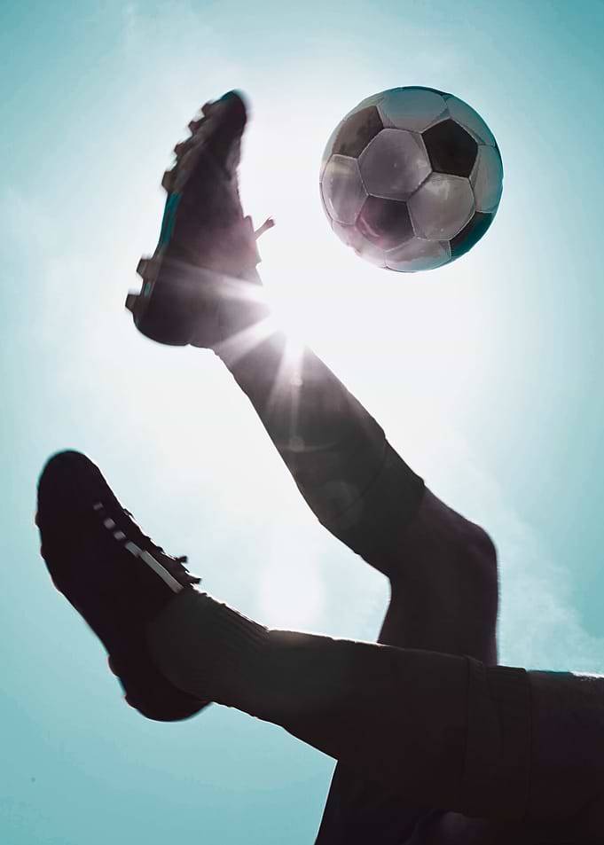 Soccer Player Kicking Ball