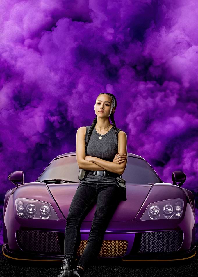 Nathalie Emmanuel leaning on a purple sports car