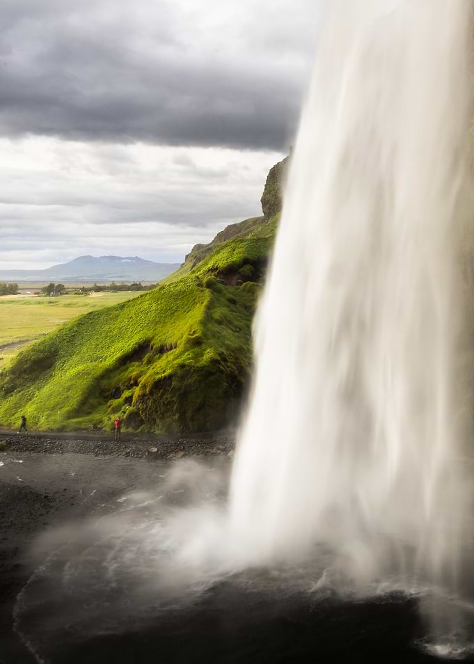 Waterfall cascading into a misty pool