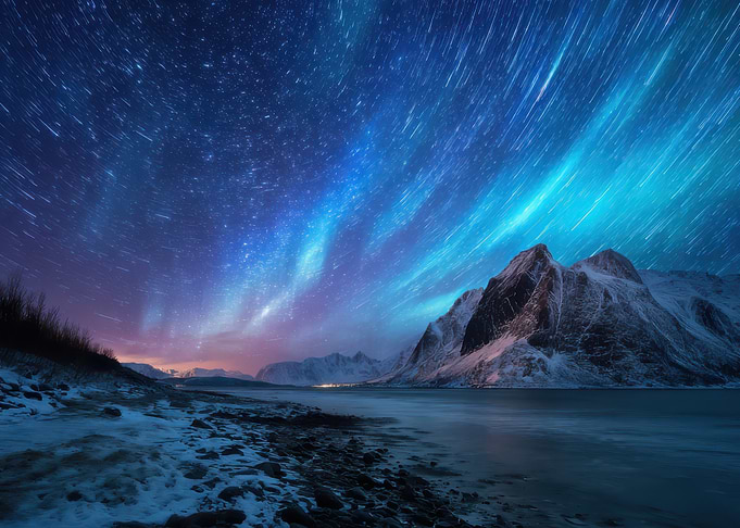 Aurora Borealis over Snowy Mountains