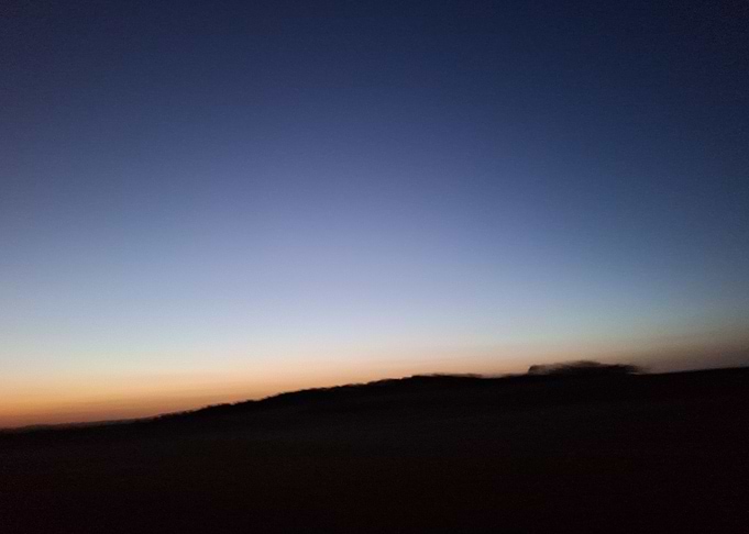 Twilight Horizon Over Rolling Hills