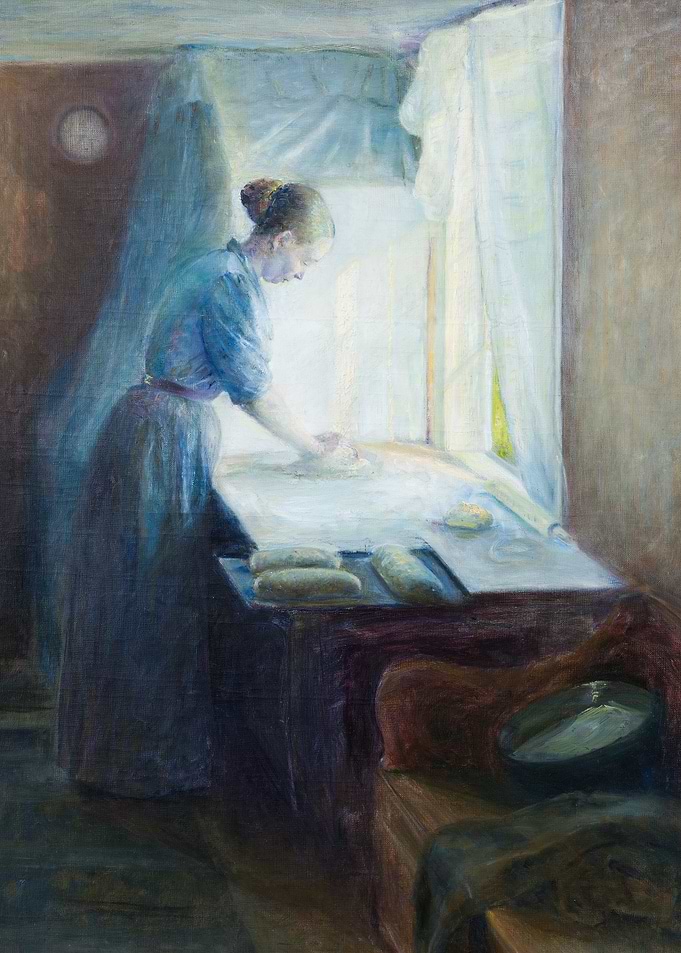Woman preparing dough by window