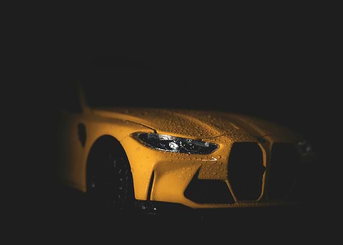 Yellow sports car with water droplets