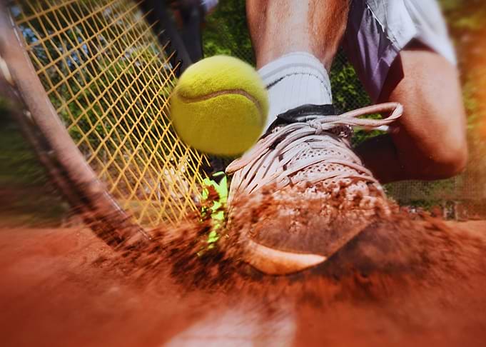 Tennis player about to hit the ball