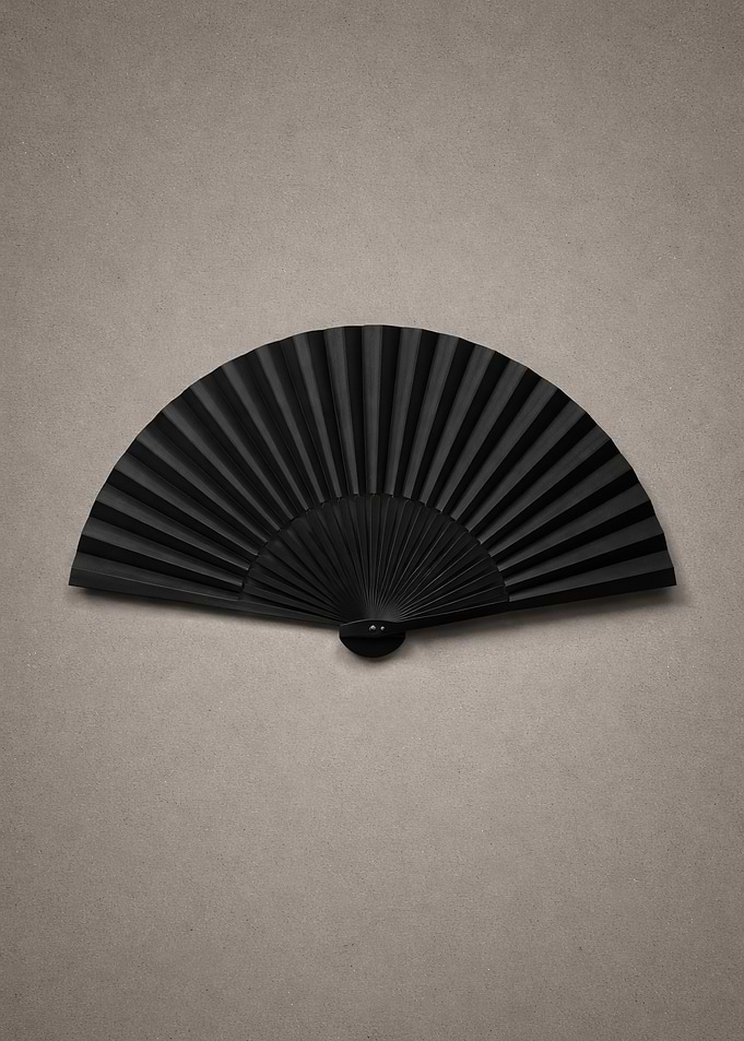 Black Folding Fan on Textured Background