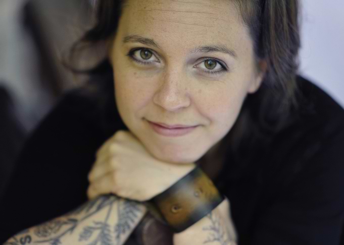 erin mckeown with tattoos and leather cuff