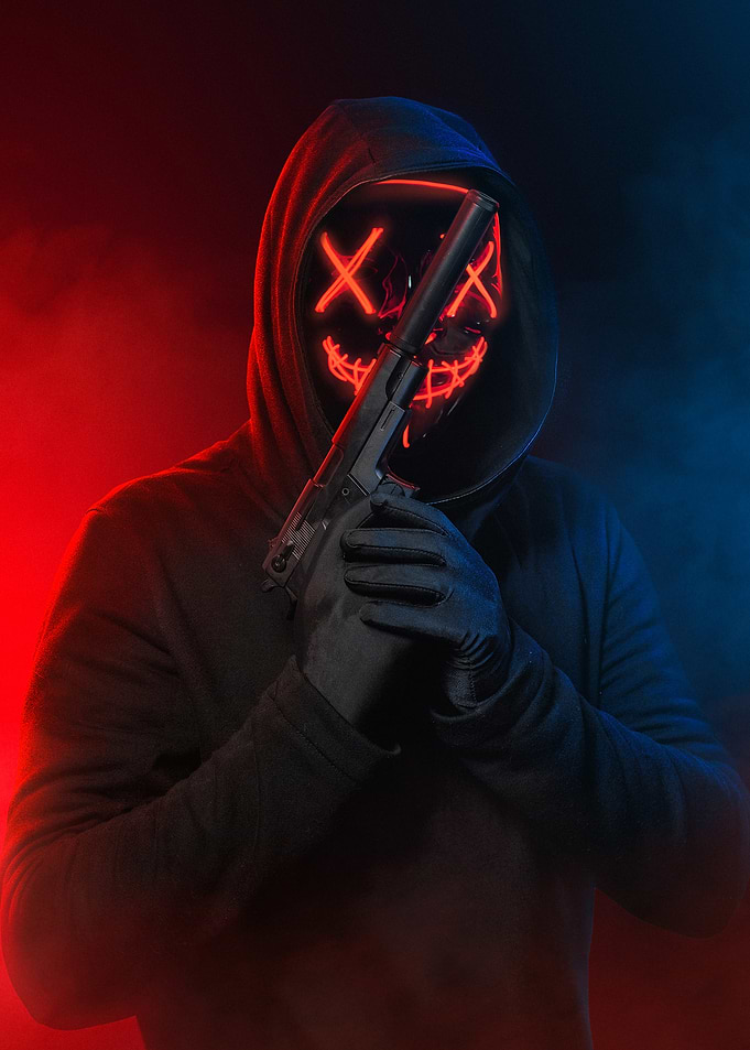 Person in Purge Mask with Gun