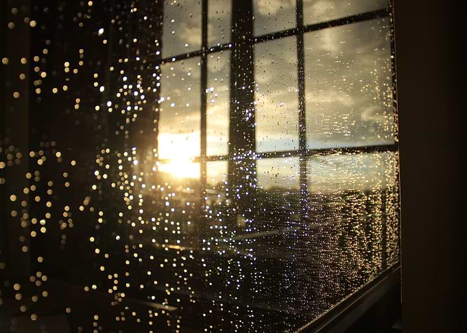 Raindrops on Window at Sunset