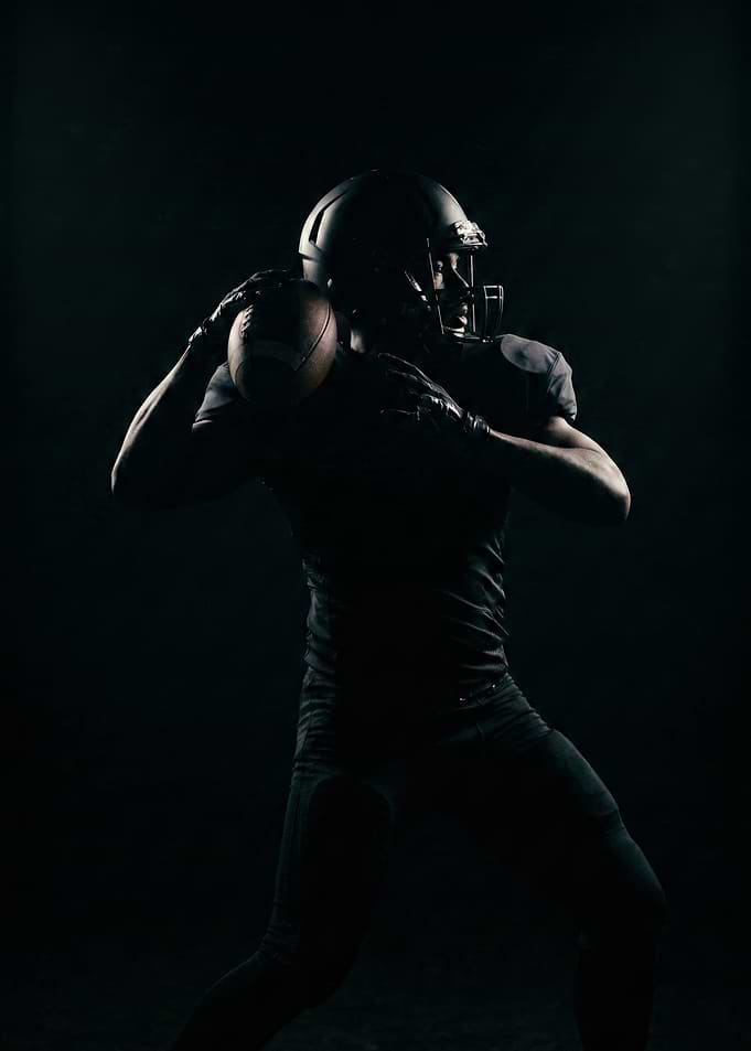 Football Player Throwing Ball