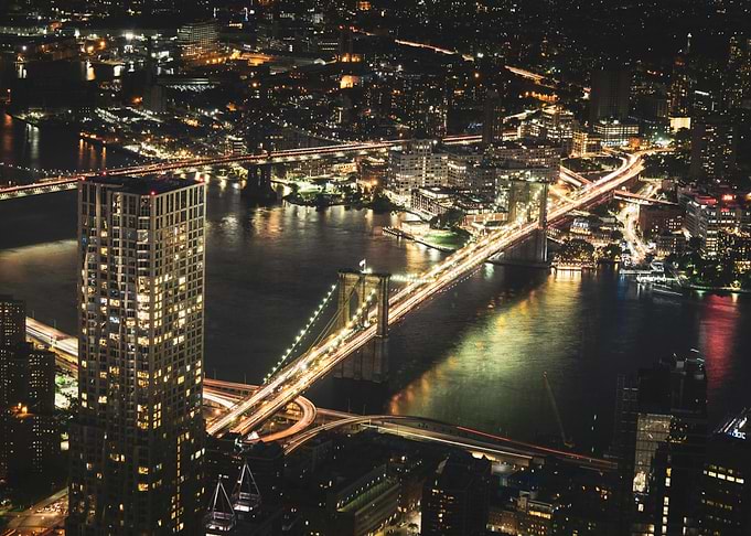 New York City, Nighttime Cityscape with Bridges and Skyscrapers