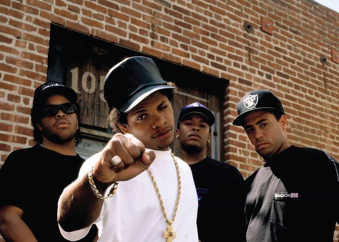 N.W.A. posing in front of a brick building