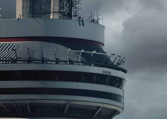 Man sitting on top of a tower