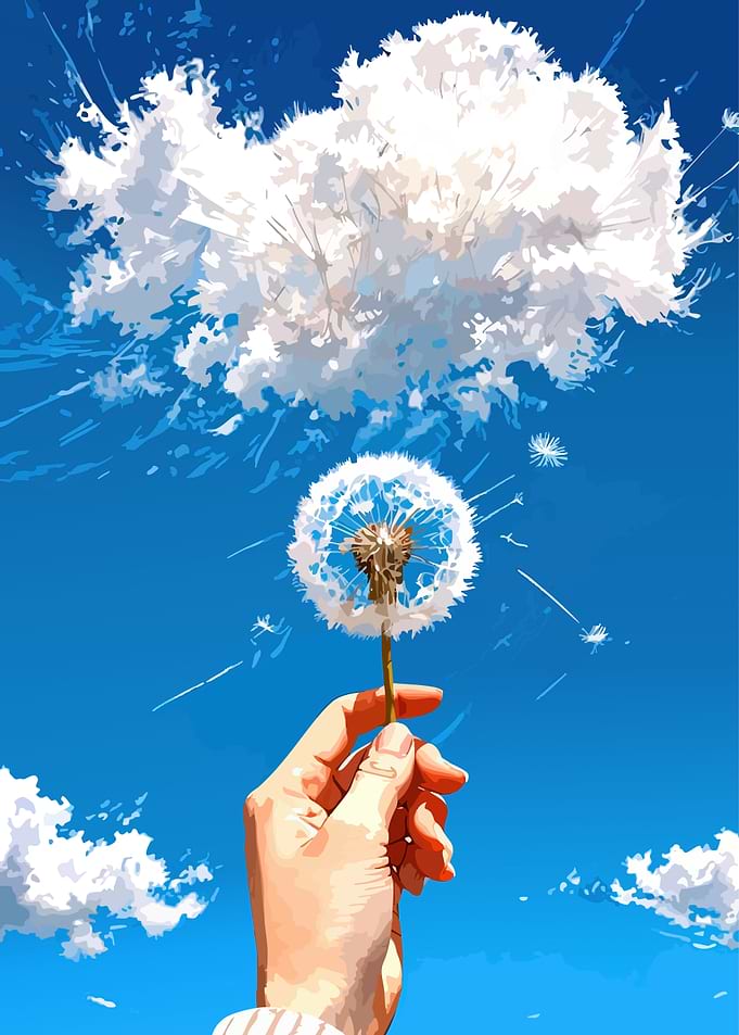 Hand holding dandelion against blue sky