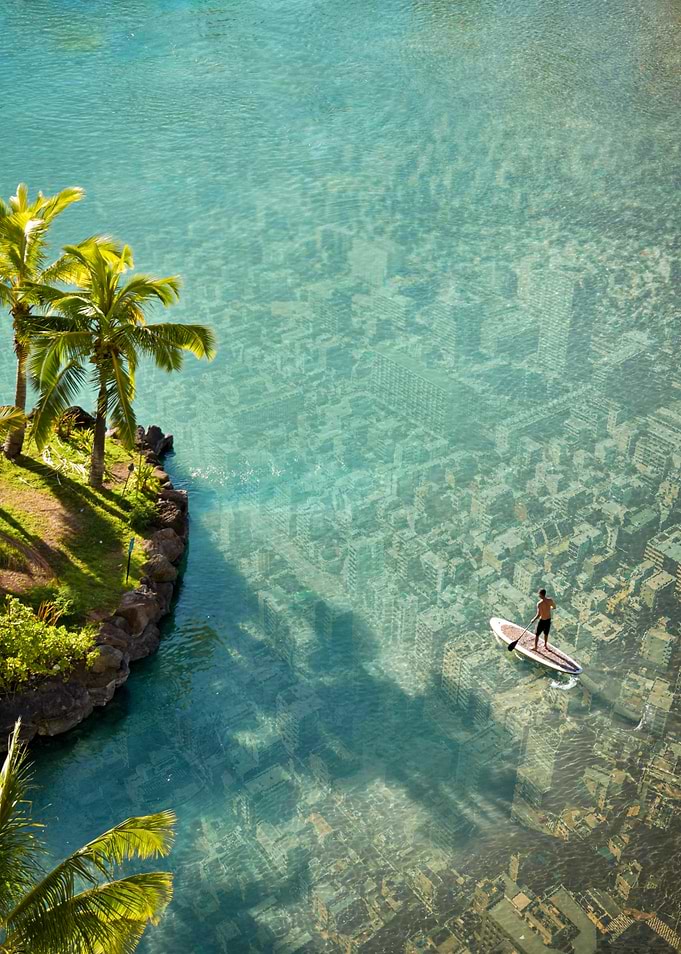 Man paddleboarding over submerged city
