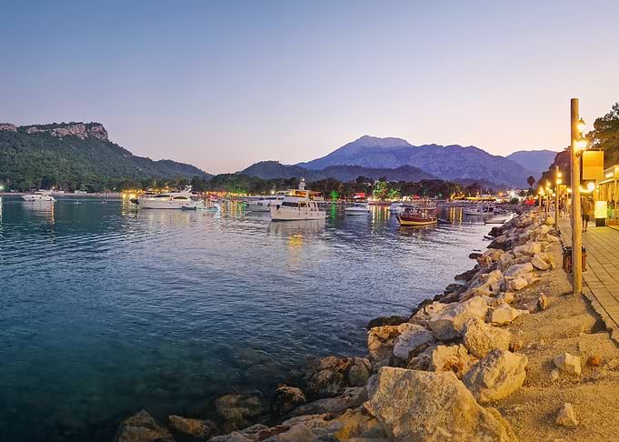 Twilight Harbor with Boats and Mountains