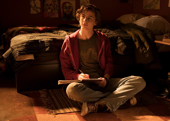 Young man writing in a notebook