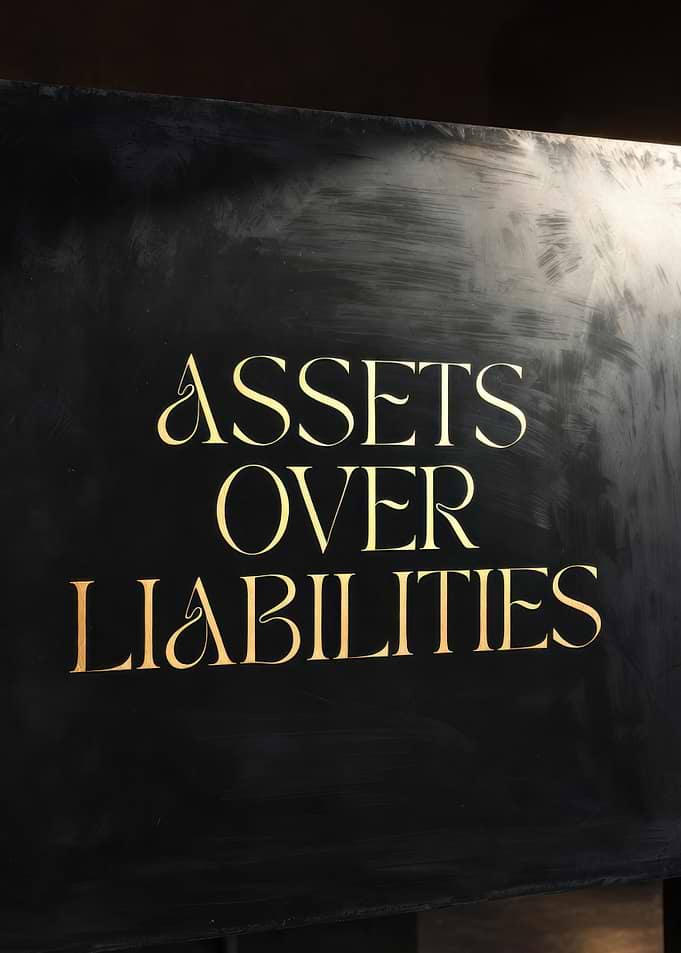 Assets Over Liabilities Text Art