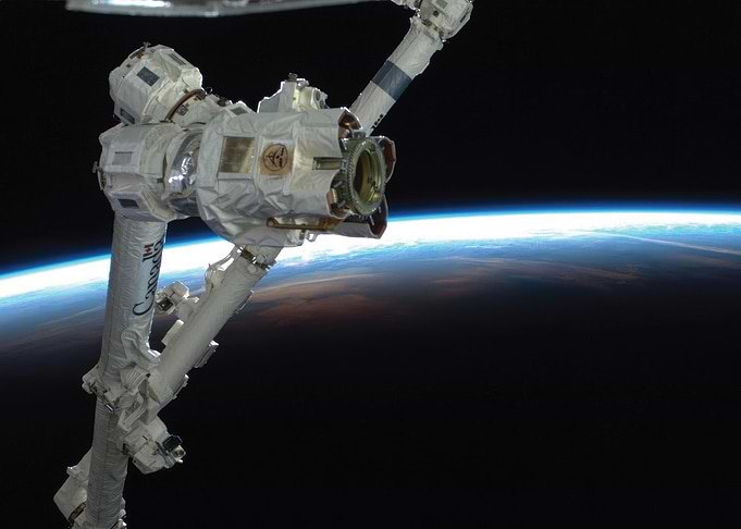 Robotic Arm in Orbit Above Earth