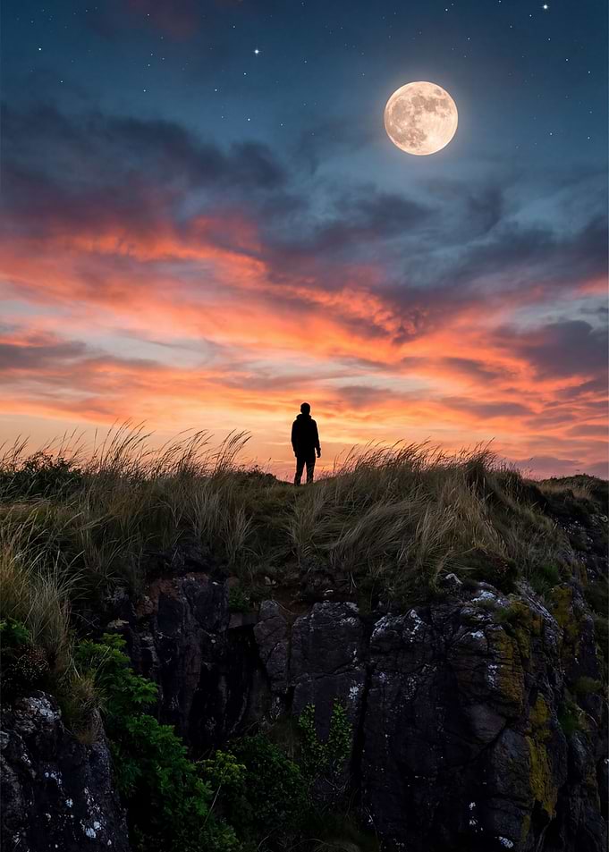 Silhouette on a cliff under the moon
