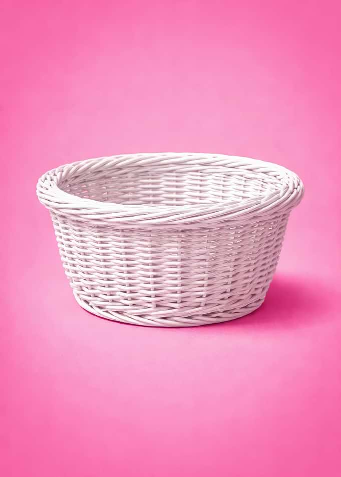 White Wicker Basket on Pink Background