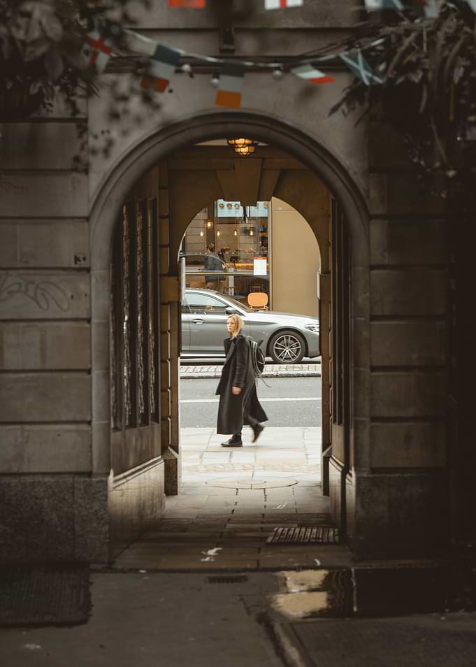 Woman walking through an archway