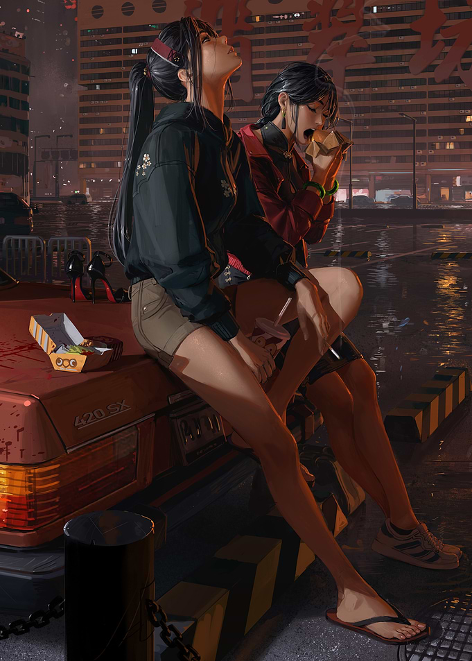 Two women eating fast food at night