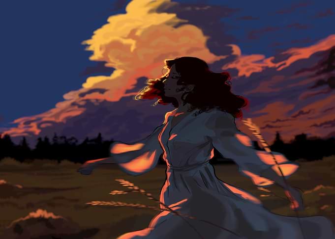 Woman in flowing dress at sunset