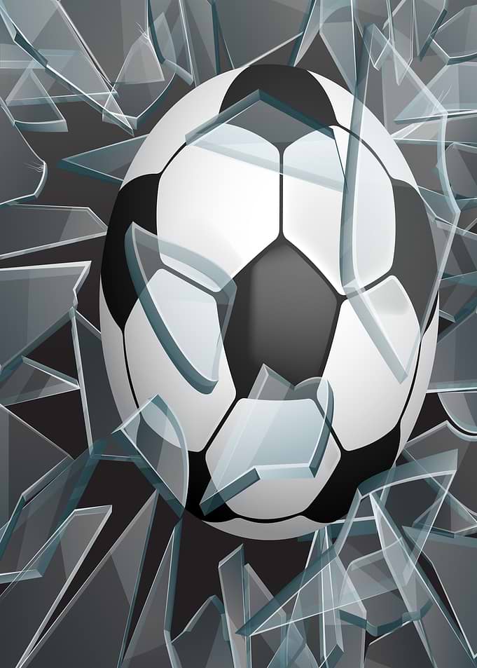 Soccer ball breaking through glass
