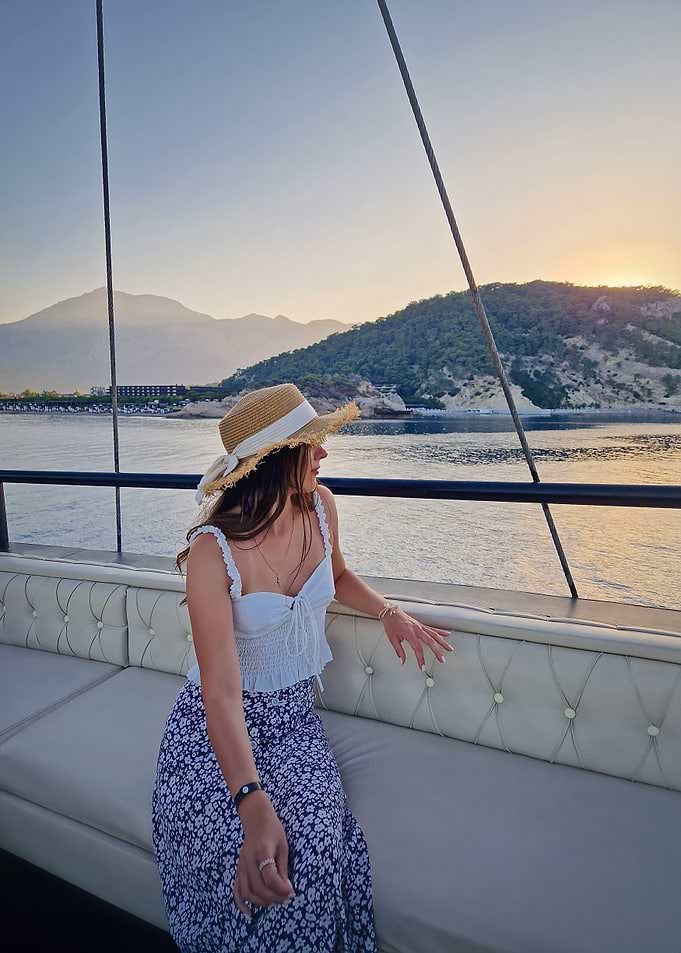 Woman on a boat at sunset