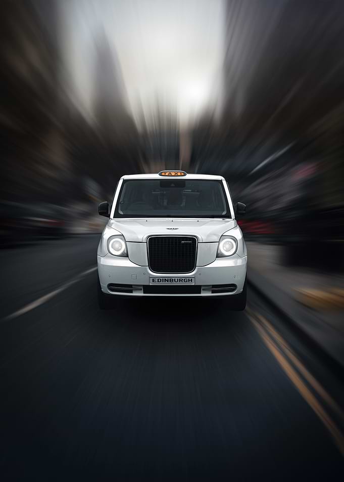 White Edinburgh Taxi in Motion