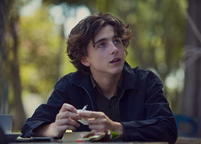 Young man looking up outdoors