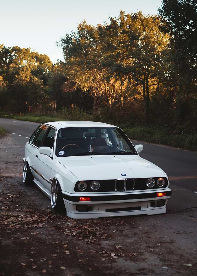 White BMW E30 on a Country Road