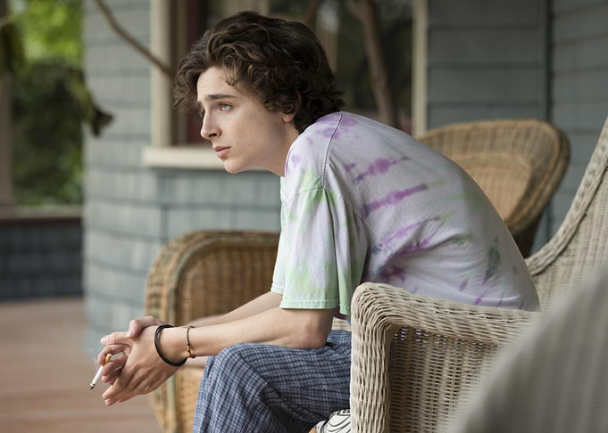 Timothée Chalamet smoking on a porch