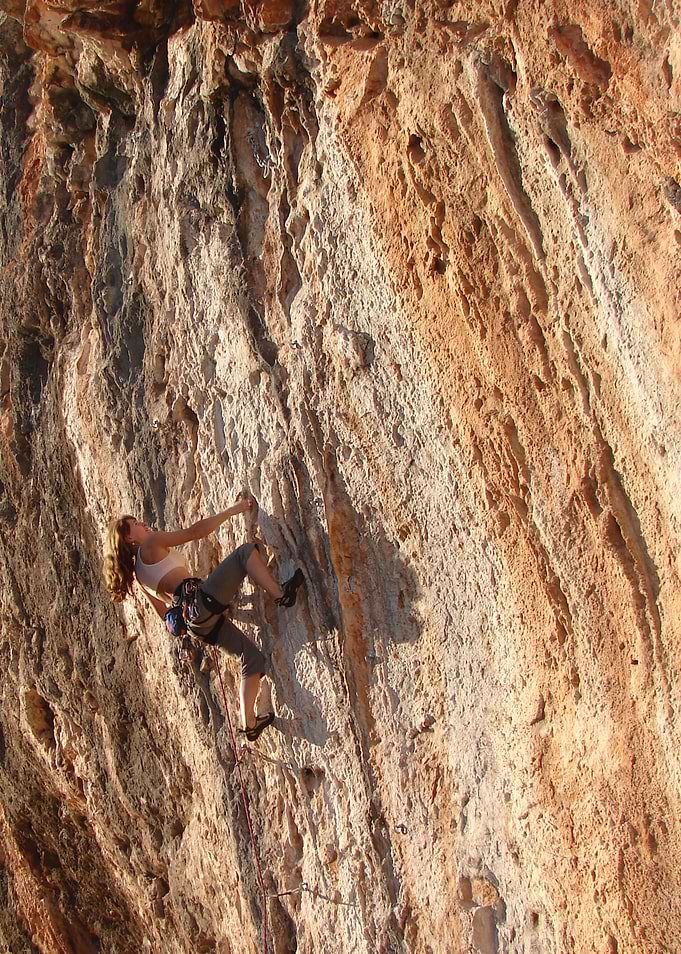 Woman rock climbing on a cliff