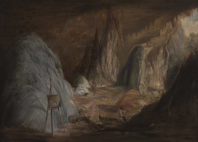 Artist painting in a cave